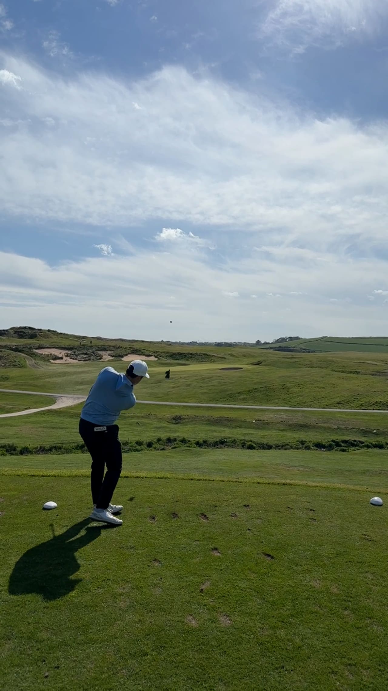 Huw Williams playing a shot on a links course