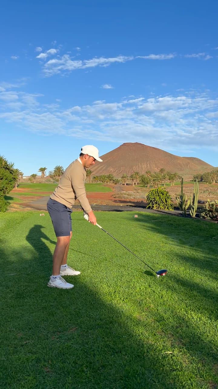 Huw Williams mid-drive on a desert resort course