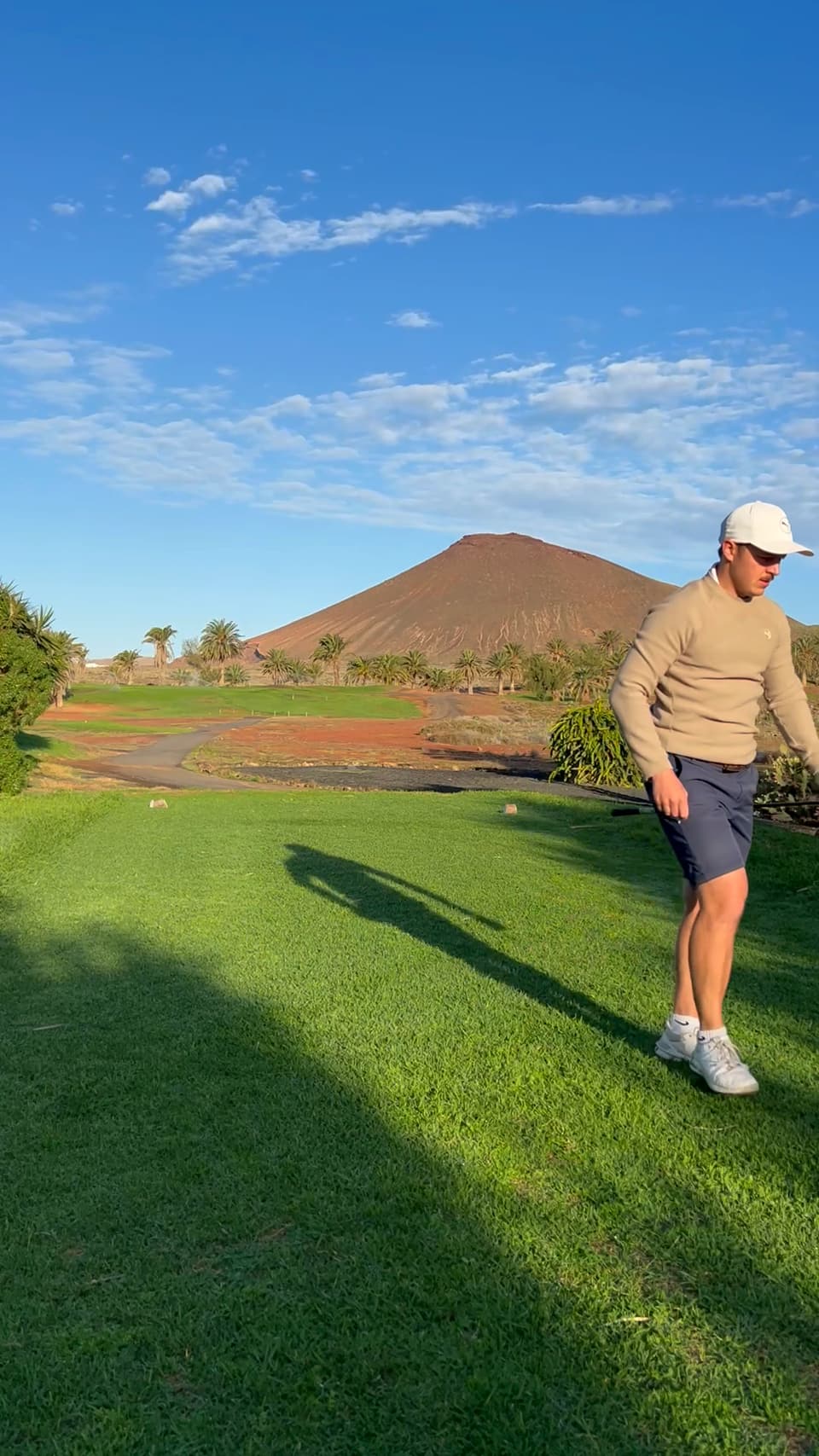 Huw Williams walking off the tee at golden hour
