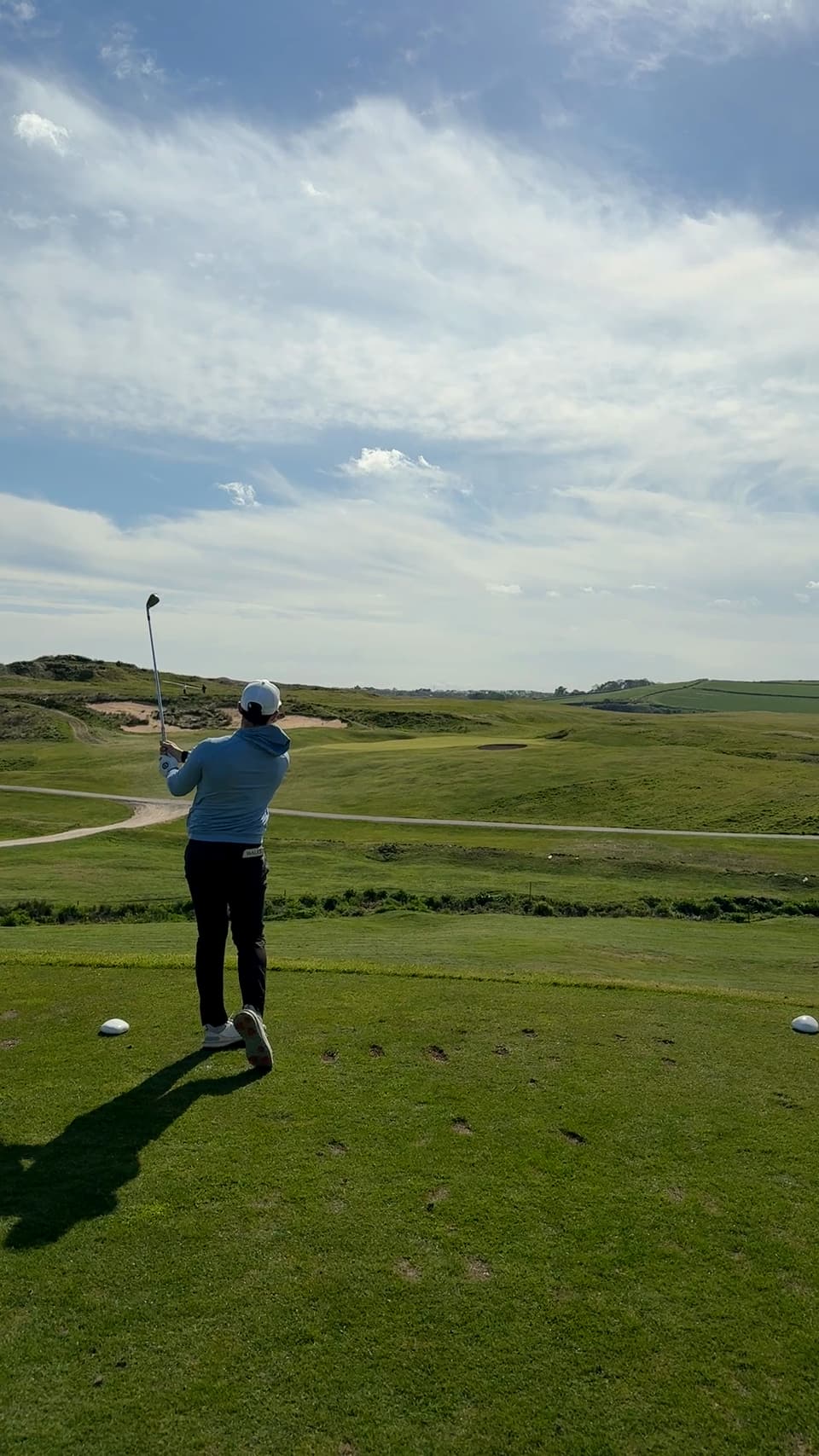 Huw Williams holding his finish on a links course, fairways running to the horizon